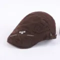 Detailed view of the brown men's cotton ivy cap with metal badge and casual design. - Adjustable / Brown