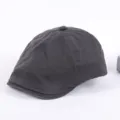 Detailed view of the dark grey cotton flat cap, showing fine stitching and classic newsboy design. - Adjustable / Dark Gray