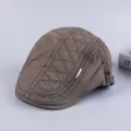 Detailed view of the quilted cotton flat cap, showing fine stitching and metal tag accent. - Adjustable / Army Green