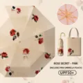 Paraguas plegable vintage con estampado de rosas, protección UV marco dorado y estuche. - Secreto de rosa - Paraguas con revestimiento de color y mango dorado