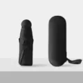 Compact mini capsule umbrella in sleek black color with matching hard protective storage case. - Round 8-Rib Sun Umbrella, Black (Full Blackout)
