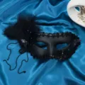 Black feather masquerade mask with crystal rhinestones and delicate hanging chains for party. - Purple Rhinestone Style