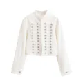 Close-up of the elegant white military-style cropped jacket featuring intricate silver buttons. - XS / Tops / White