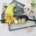 Masquerade half mask with yellow feathers and gold flower for party ball costume dress up. - Gold