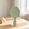 Specchio da trucco a mano verde macaron con semplice manico ovale, design elegante. - Verde chiaro