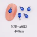 Close-up detail of teardrop blue crystal nail art charms, alloy base, shiny rhinestones 4x8mm - Deep Blue Water Drop (A952) / Single Piece (4x8mm)