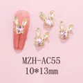 Detailed view of 3D bunny rabbit nail art charms with pink heart rhinestones, alloy gold finish. - AC55 Pink