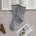 Grey cotton mid-tube socks featuring cute pink tulip floral pattern and elegant black ruffled cuffs. - One Size / Light Gray