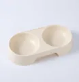 Close-up detail of the plastic double pet bowl featuring smooth curves and anti-overturn base. - Apricot