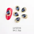 Drop-shaped blue rhinestone nail art charms with shimmering crystal border for luxury nails. - 5723