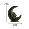 Resin moon face sculpture detail shot, vintage celestial tarot art ornament showing texture. - Black