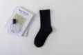 Solid black mid-calf socks for women, minimalist daily casual wear, cozy cotton knitwear. - Female Style / Black