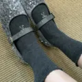 Gray mid-tube socks featuring delicate embroidery paired with silver sequin shoes for women. - Gray