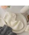 Close-up detail of summer thin mesh lace women socks, breathable hollow out design aesthetic. - Creamy White
