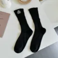 Women black ribbed mid-calf socks with embroidered letter detail, chic daily casual wear. - One Size / Black