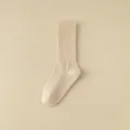 Beige mid-calf pilates yoga socks with anti-slip silicone grip soles for indoor workouts. - One Size / Light Khaki