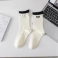Fall winter contrast color mid tube socks with delicate ruffles and stylish letter embroidery. - One Size / White