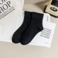 Solid black mid-calf cotton socks for women, comfortable daily casual wear ins style. - One Size / Black