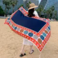 Ethnic style beach shawl detail view, showing colorful floral geometric borders and soft fabric. - 318