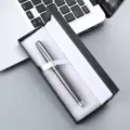 Close-up detail of a sleek metallic signature pen in an elegant black gift box on desk. - 041 Pen Box / Gray