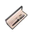 Close-up detail of luxury metal signature pen set with black gift box and beige velvet lining. - Black Pen with Silver Trim + Single Refill Pen Box