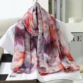 Detail view of a large faux silk floral print scarf, elegant garden design, soft texture. - 4