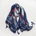 Detailed view of the navy blue printed tassel scarf, showing intricate floral patterns and fabric texture. - Style 1