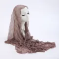 Close-up detail of the lightweight taupe lace headscarf, showing the soft sheer texture and delicate drape. - 12
