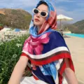 Floral square scarf detail showing vibrant blue and pink flower print with chic striped border. - Style 8