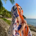 Beach sun protection floral shawl with bright orange border, stylish holiday accessory. - 2317