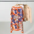 Detailed view of women's orange floral loose boat neck imitation silk sun protection top. - 90X90cm Loose Short Style / Style 2