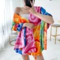 Detail view of colorful abstract print beach shawl, vibrant color block scarf with tassels. - L269