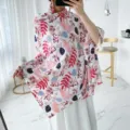 Detailed view of a sweet floral printed scarf shawl, perfect for spring trips and beach photos. - L256