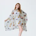 Close-up detail of lightweight chiffon poncho with autumn leaf print for summer beach vacation. - Style 3