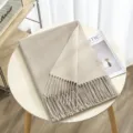 Detailed view of cozy thickened double-sided solid color fringed cashmere-feel scarf in beige. - Color 15