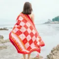 Detail view of ethnic style red geometric print beach towel and sun protection shawl. - Over 175cm / L18-2