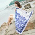 Outdoor beach detail view of women's ethnic style long linen scarf with blue floral print. - L184