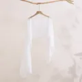 Detailed view of white summer sun protection lightweight shawl long sleeve cover-up top. - White
