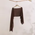 Close-up detail of a brown sheer long sleeve sun protection shrug cardigan hanging nicely. - Coffee