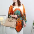 Detail view of the elegant imitation silk sun protection cape featuring vibrant tree leaf print. - Style 14