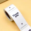 Roll of white thank you stickers with heart design, ideal for gift packaging and wedding seals. - White