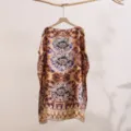 Detailed view of the loose printed silk-like sun protection shawl featuring artistic round tie-dye. - 17