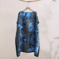 Close-up detail view of blue leopard print silky sun protection shawl, lightweight. - 9