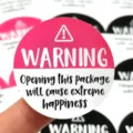 Detailed view of round warning sealing sticker, fun gift box packaging decorative label - Rose Red