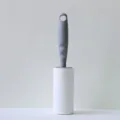 Lint roller for clothes hair removal with gray handle and replaceable white sticky paper roll. - Phantom Grey