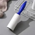 Lint roller with blue handle and white adhesive paper roll for cleaning clothes and removing dust easily. - Blue (Includes 1 Paper Roll)