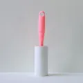 Pink handle lint roller with replaceable white sticky paper for easy clothes hair dust removal. - Rose Pink
