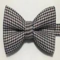 Detailed shot of classic houndstooth bow tie in black and brown pattern, elegant men accessory. - Houndstooth 3