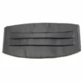 Detail view of the black pleated cummerbund, showing fine satin fabric and neat pleat texture. - Black