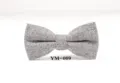 Grey herringbone wool bow tie detail showing fine fabric texture and neat tailoring shape. - YM-009